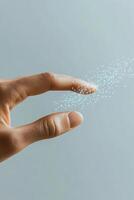 Hand touches digital sparkles. Artificial network connection. Light dots float from a finger. Neural networks abstract concept on plain background photo
