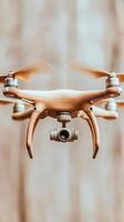 Flying device floats with spinning propellers. Small camera attached. Aerial view in front of light wood background. Modern technology and innovation concept. photo