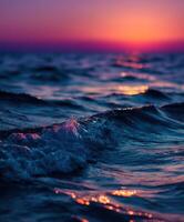 Sunset over ocean waves creates a tranquil evening atmosphere photo