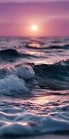 Sunset over waves creating ripples at the ocean shore photo
