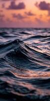 Sunset colors reflected in ocean waves at twilight photo