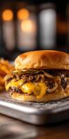 Juicy burger with melted cheese and grilled onions on a plate photo