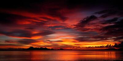 Dramatic sunset over calm water with distant islands photo