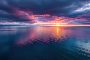 A beautiful sunset over the ocean with clouds photo