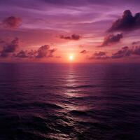 Beautiful sunset over the calm ocean with purple sky photo