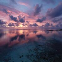 Stunning sunset over calm ocean waters at coastal location photo