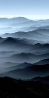 Expansive mountain range shrouded in mist at dawn photo
