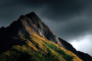 Majestic mountain with autumn colors under dark clouds photo