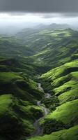 Lush green hills with a winding river under a cloudy sky photo
