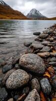Rocky shoreline with tranquil water reflections photo