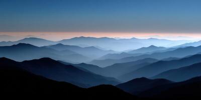 Majestic mountain range under twilight sky with soft haze photo