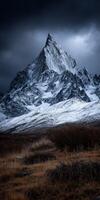 Majestic mountain peak under dark clouds in a winter landscape photo