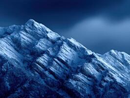 Majestic snow-covered mountains under dark clouds at twilight photo