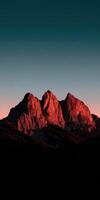 Majestic mountains illuminated by sunset glow in the sky photo