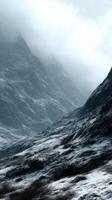 Snowy mountain landscape shrouded in misty clouds photo