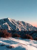 Majestic snow-covered mountains during sunset in winter photo