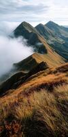 Serene mountains enveloped in mist under a clear sky photo