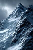 Snowy mountain peaks under dramatic cloudy sky in winter photo