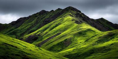 Lush green mountain peaks under a moody sky photo