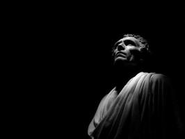 Historical figure gazing upward in contemplation under dramatic lighting photo