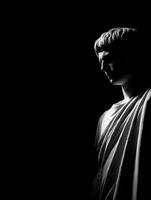 Stoic bust of a Roman figure captured in dramatic lighting against a dark background photo