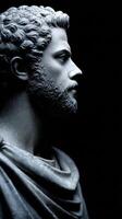 Stoic statue depicting a thoughtful figure in a darkened setting photo