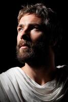 Stoic man with thoughtful expression against dark background photo