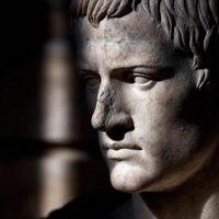 Stoic marble bust of a historical figure illuminated by soft light photo