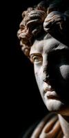 Stoic marble sculpture with expressive features displayed in dim lighting photo