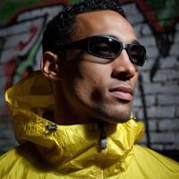 Bold fashion statement featuring a model in a vibrant yellow jacket with sunglasses photo
