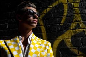A man in a yellow checkered suit and sunglasses photo