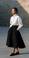 Elegant woman in a stylish outfit walks confidently in urban setting photo