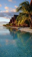Luxurious waterfront villas basking in the glowing sunset on a tropical island photo