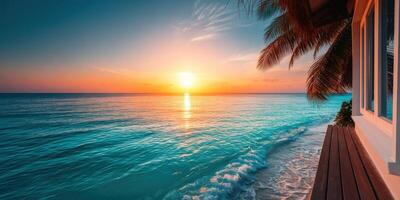 Sunset over calm ocean waves by tropical beach resort with palm trees photo