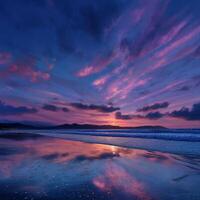 Sunset over a tranquil beach with vibrant colors reflecting on the water photo
