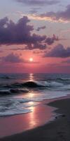 Sunset over calm ocean waves at a serene beach location photo
