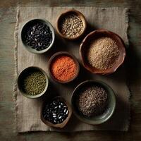 Colorful assortment of dried legumes and grains on a fabric surface photo