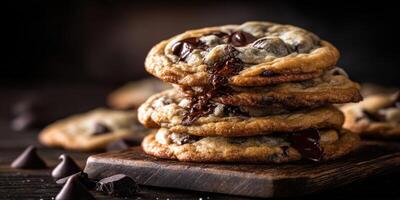 Homemade chocolate chip cookies stacked on a wooden board with melting chocolate photo