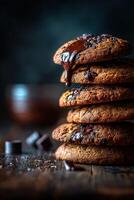 Warm chocolate chip cookies stacked high with melted chocolate dripping photo