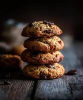 Delicious chocolate chip cookies stacked on a rustic wooden table photo
