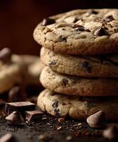 Deliciously baked chocolate chip cookies stacked on a dark background photo