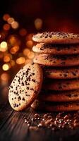 Stacked chocolate chip cookies on a rustic wooden table with warm bokeh lights photo
