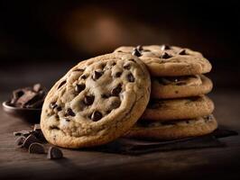 Chocolate chip cookies stacked on a wooden table with dark background photo