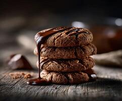 Delicious chocolate cookies stacked on wooden table with melting drizzle photo