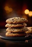 Deliciously baked chocolate chip cookies stacked on a dark plate photo