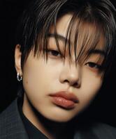 Portrait of a young individual with stylish hairstyle and subtle expression photo