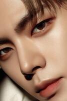 Close-up portrait of a young man showcasing expressive features and smooth skin photo