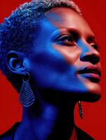 Woman with short hair and bold earrings against a vibrant background photo