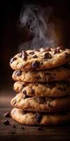 Freshly baked chocolate chip cookies stacked with steam rising photo