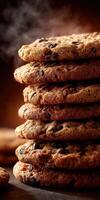 Delicious freshly baked chocolate chip cookies stacked on a wooden surface photo